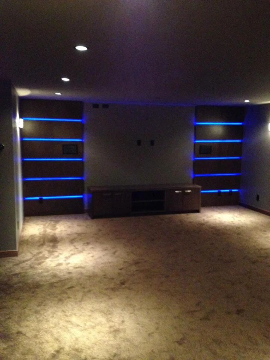 Custom entertainment room with LED shelving and media center — home renovation Richmond BC